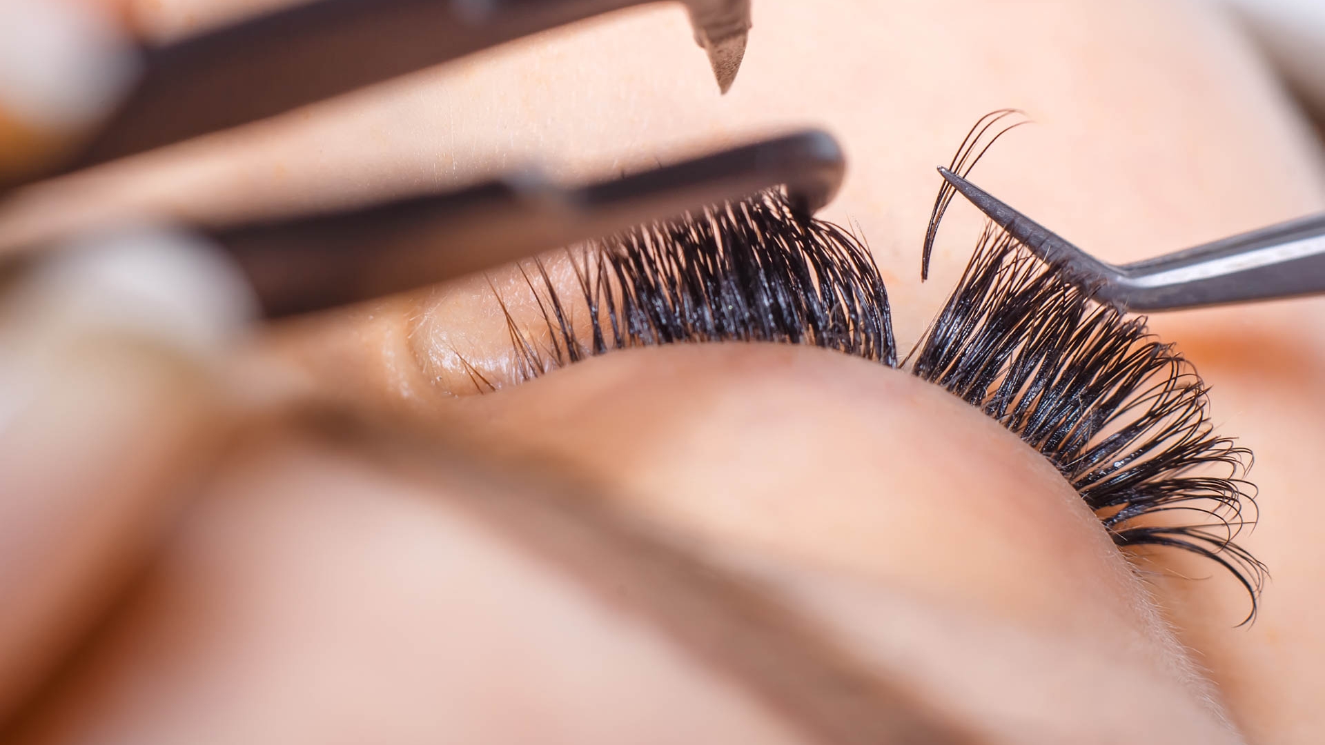 Eyelash Extension Procedure. Woman Eye with Long Eyelashes. Lashes. Close up, macro, selective focus